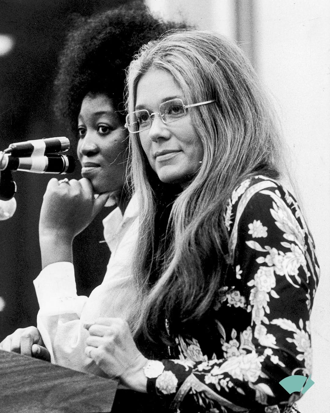 Gloria Steinem seated beside activist Dorothy Pitman Hughes during a public event.